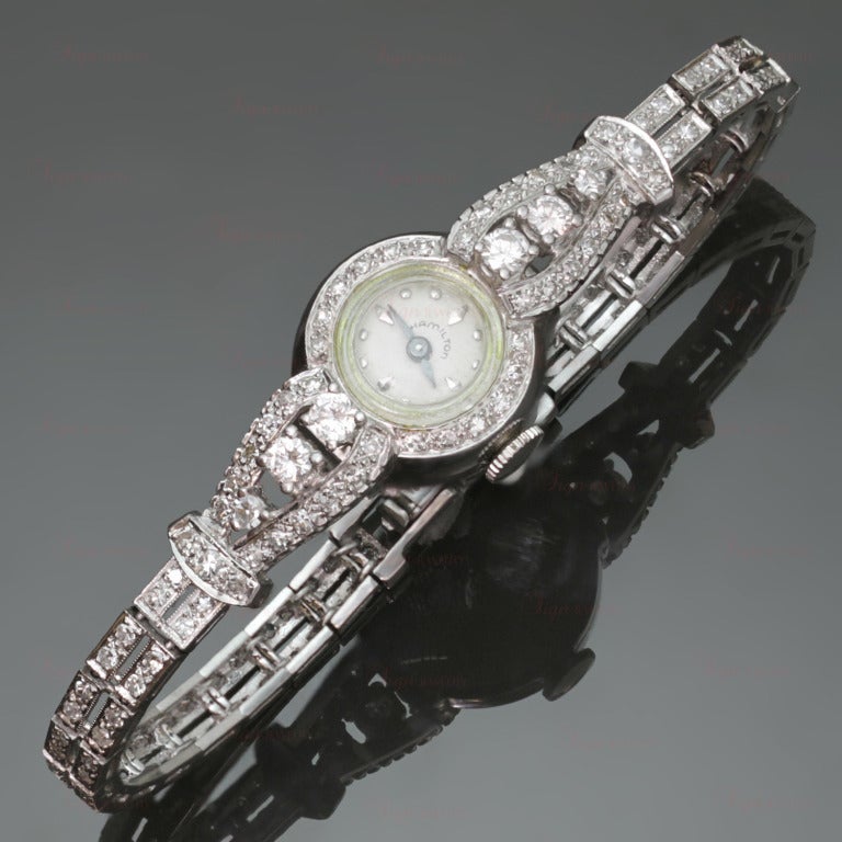 This stunning lady's bracelet watch is made in platinum and set with 88 sparkling round diamonds of an estimated 2.80 carats. Completed with manual wind movement by Hamilton. Circa 1950s.