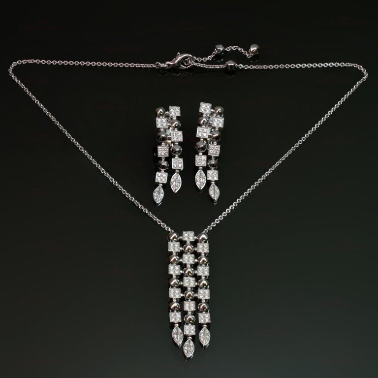 This fabulous jewelry set from Bvlgari's famous Lucea collection features an iconic design of geometric shapes and consists of a drop necklace with an adjustable chain and a matching pair of dangling earrings. Made in 18k white gold, there is an