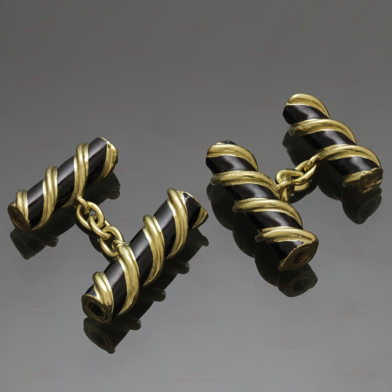 These estate men's cufflinks are designed by Schlumberger for Tiffany & Co. and feature a chic design of twisted rolls made in 18kt yellow gold and black enamel. Classic elegance.