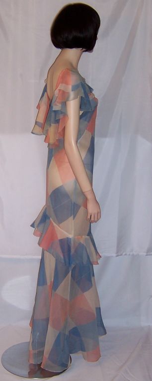 This is one of the most beautiful 1930's printed chiffon gowns that I have ever purchased. It is unique in its coloration. Pink, white, turquoise, and cornflower blue make up its color palette, not unlike those colors worn by the costumed Harlequins