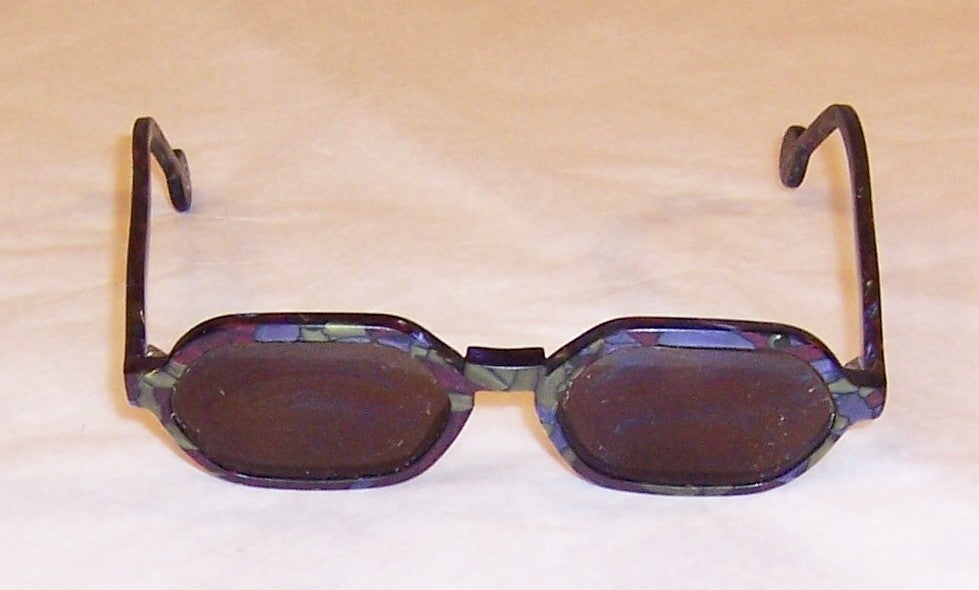 Offered for sale is this cool and funky pair of L.A. Eyeworks frames. They are prescription sunglasses, so the lenses would have to be changed. They are hand-made in motled hues of lavender, magenta, and gray and are in excellent vintage