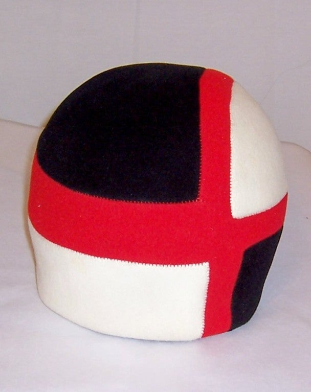 This is an unusual 1960's vintage, Mod, color-blocked wool felt helmet hat, custom-made in red, black, and white.  It is somewhat reminiscent of the 1920's cloche hats.  This hat is in excellent vintage condition and its circumference measures 22