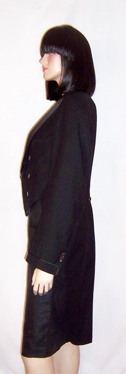 This is a wonderful, early 20th century, men's black morning jacket with tails.  It could just as easily be worn by a woman.  The jacket is wool with satin lapels and six buttons, plus two smaller buttons for closure. It measures 34