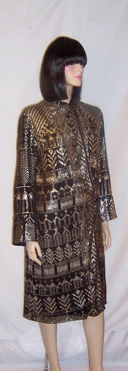 This is a dramatic and beautifully designed 1920's vintage, black and silver Egyptian Assuit coat of substantial weight and  in minty condition.  The coat has one button for closure at the hip line and one snap for closure at its neckline.  The coat