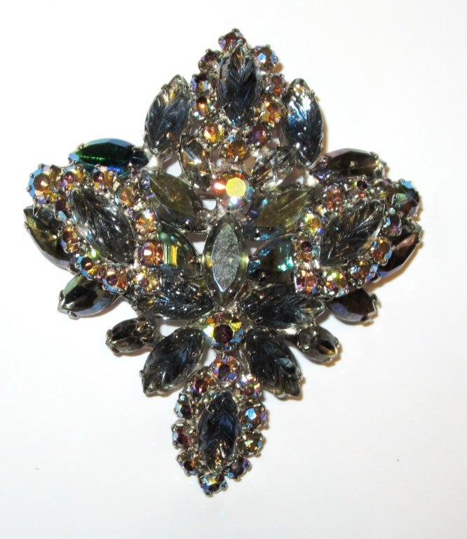 This is an impressive, large rhinestone brooch in hues of gray, green, blue, and clear AB stones.  The brooch is comprised of 10 molded/poured glass marquis-shaped stones surrounded by
small rounded rhinestones and additional marquis-shaped stones