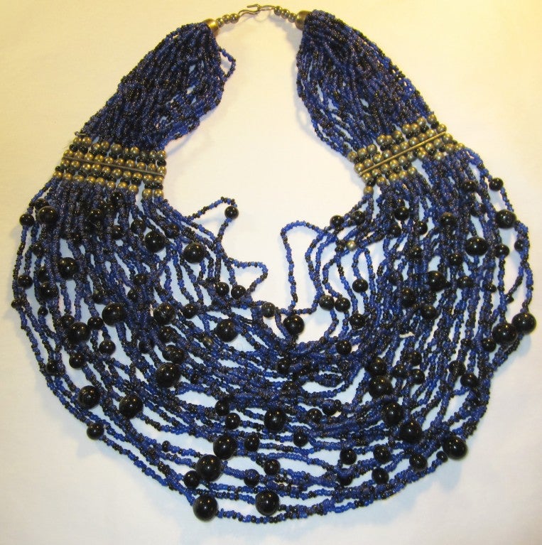 This is an impressive and dramatic multi-strand (30), glass beaded necklace which measures 18