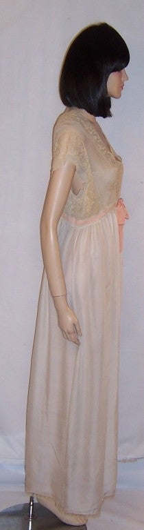 This is an exquisite Edwardian bride's, hand-made silk three piece trousseau consisting of a pair of pants or half slip, a long camisole, and a gorgeous peignoir each trimmed in bands of delicate lace and apricot silk ribbons.  There is a tiny hole,