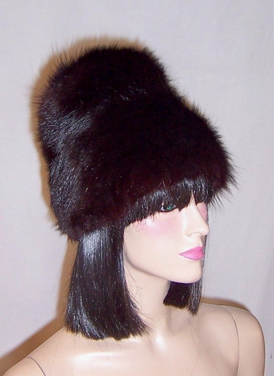 This is a lovely and dramatic, 1960's vintage, black fox fur hat whose crown measures 8