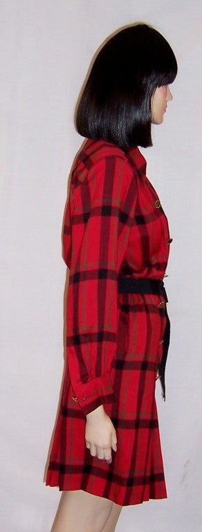 This is a wonderful Yves Saint Laurent-Rive Gauche-red and black plaid, double-breasted day dress with its own black ribboned belt.  It is in excellent vintage condition and is marked a Size 34 EU which is equivalent to a Size 4 US.
