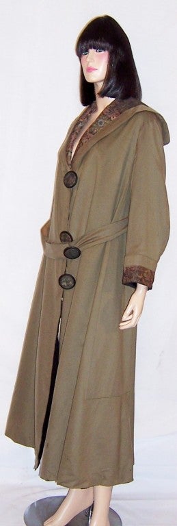 This is a wonderful Edwardian (circa 1913-1919) single-breasted, belted, coat with three large fabric-covered buttons, and matching tapestry collar and cuffs.  The coat is being sold in 