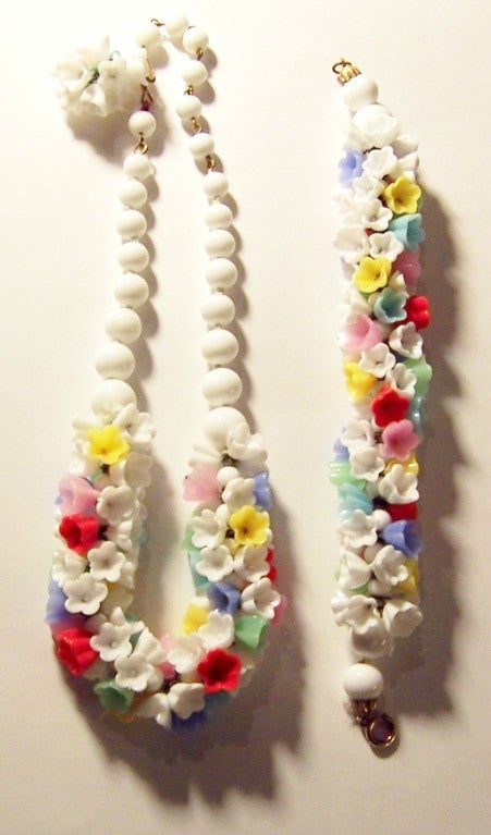 This is an unusual, unique, and whimsical Pate de Verre (poured glass) necklace and bracelet set comprised of multi-colored glass florets on a white beaded chain.  The necklace measures 17