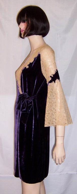This is a lovely and luxurious, 1920's vintage, eggplant colored silk velvet peignoir embellished with ecru lace around the neckline and bell-shaped sleeves. The peignoir has two velvet sashes that have been tied into a bow for closure. It is in