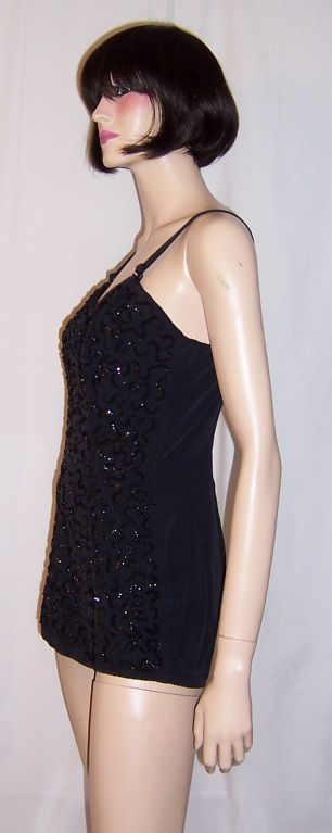 This is a stunning 1950's Original by Tobi of California black sequined bathing suit. Marilyn Monroe had been photographed in one almost identical to this one many years ago. It is in excellent vintage condition and would be comparable to a size 6/8.