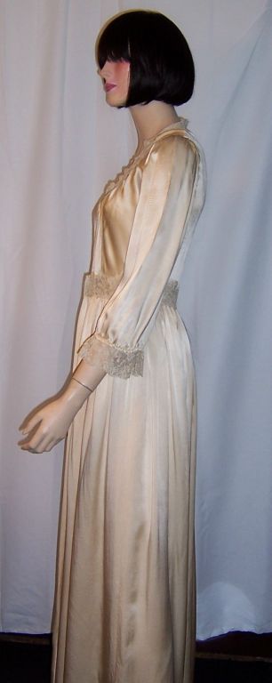 This is the matching vintage peignoir to the negligee I have listed. This lovely champagne colored silk peignoir is buttery soft and has fine lace trim around the neckline, sleeves, and waist line. It also has a draw-stringed tie around the waist. 