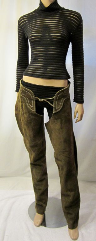 Offered for sale is this fantastic pair of brown suede cowgirl/cowboy Western chaps. Each leg has a side zipper for accessibility and the chaps have a belted buckle in the front which is adjustable. The back is also belted and is adjustable with the