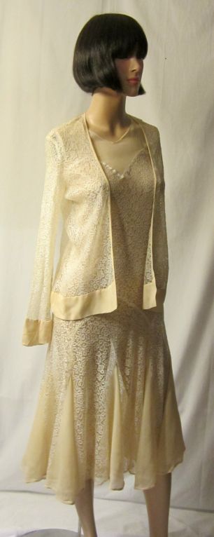 This is an incredibly beautiful, smart and sassy 1920's vintage, two-piece ensemble. The dress has a chiffon neckline, lace bodice, fitted hip line, and flared skirt. The lace skirt has a series of chiffon inserts encircling it. The dress has a
