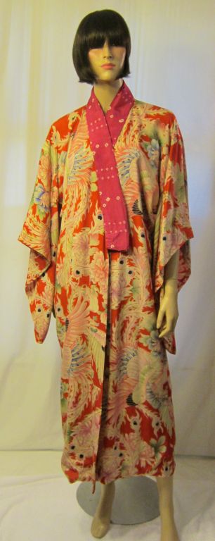 Offered for sale is this extraordinary silk printed Japanese kimono in hues of pink, magenta, and red. The inside of the kimono has been lined in pink silk and the interior, as well as the exterior, is in excellent vintage condition. The kimono