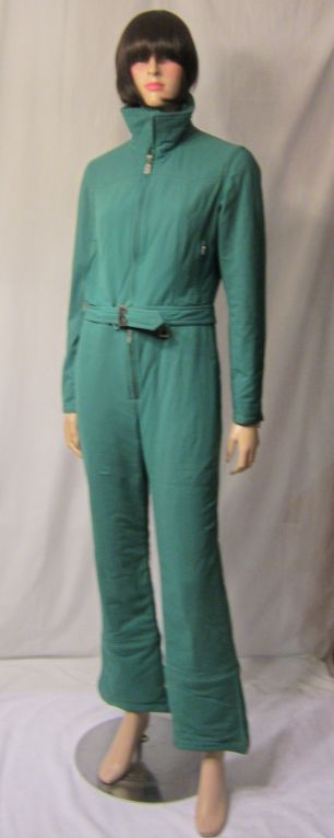 This is an ingeniously designed viridian green ski suit which appears to be an all-in-one jumpsuit when worn but is actually made of two pieces for easy accessibility. The jacket not only has a front zipper for closure but also has a zipper around