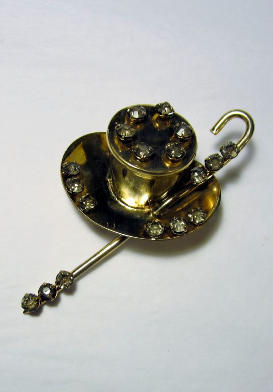 This is a fantastic, gold wash over sterling, top hat and cane brooch embellished with hand-set rhinestones. The brooch measures 3 1/4