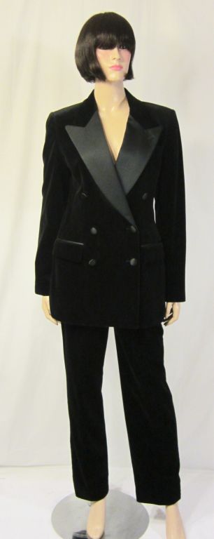 This is a stunning and striking Bill Blass black velvet and satin double breasted tuxedo jacket with wide satin lapels and two flap pockets. The jacket is a Size 6. The matching black velvet pants are a Size 4 and are beautifully constructed with a