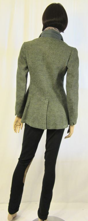 This is a beautifully constructed single breasted, teal blue tweed riding jacket, of the 1930's vintage, with navy pants of a stretchy material and tan suede patches on the inner portion of each pant leg. The jacket skims over the waist and hips