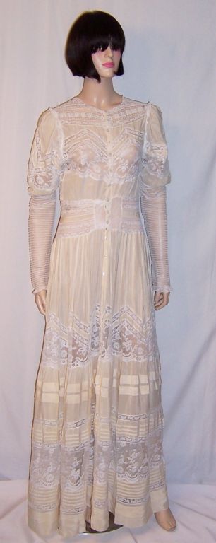 This is an amazingly beautiful, palest of yellow silk Edwardian, museum deaccession, floor length gown. It is elaborately embellished with fine Brussels bobbin lace, bands of  Valenciennes lace, and narrow, medium, and wide pintucks galore. All of