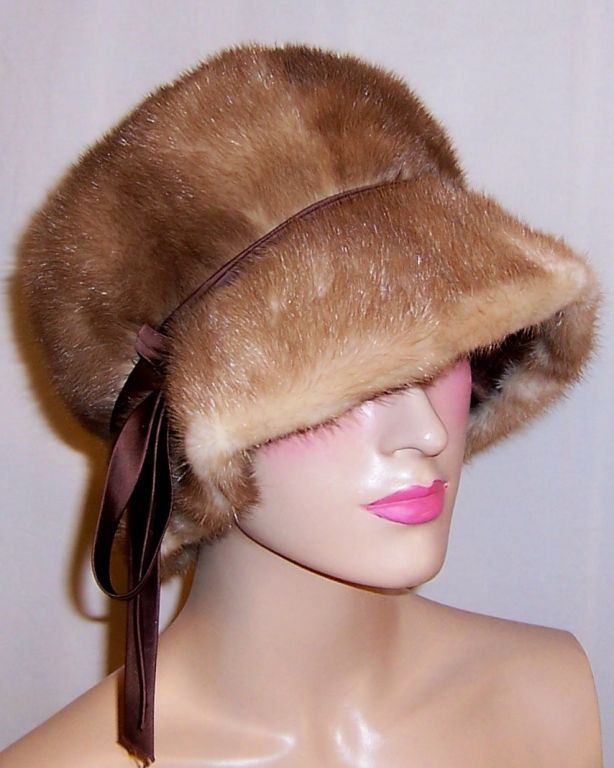 This is a striking and dramatic Autumn Haze mink cloche-type hat designed by the prestigious American milliner, G. Howard Hodge, whose work has been represented in the Metropolitan Museum's Costume Institute. The hat is close fitting and worn pulled
