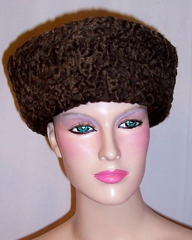 Offered for sale is this unusually striking, 1940's vintage, brown Persian lamb hat with a sheared beaver crown. The interior is just as extraordinary as is the exterior. The lining is a rich burgundy colored fabric with fine trapunto stitching. The