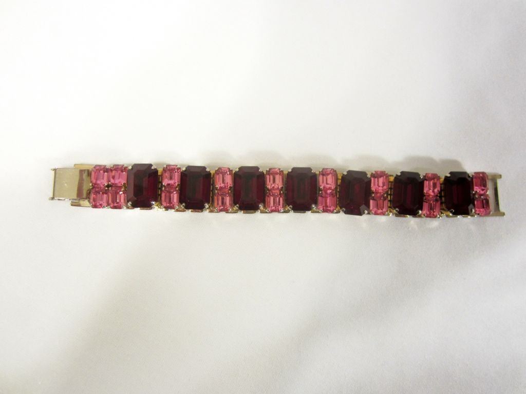 This is a stunning red and pink emerald cut rhinestone bracelet by Coro. The bracelet measures 7