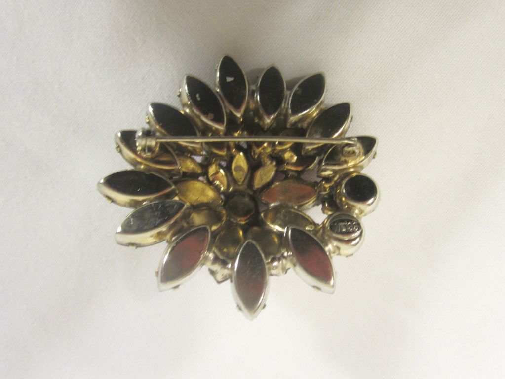 This is an extraordinarily beautiful and impressive floral brooch created by Weiss in layers of ruby red and raspberry pink rhinestones. The brooch measures 2