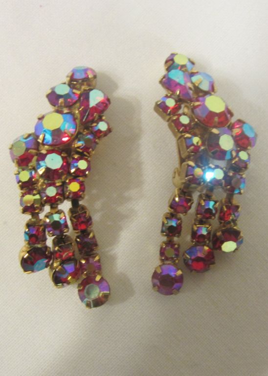 This is a lovely pair of large pink iridescent, clip-on earrings consisting of varying sized and shaped pronged-set stones. Each earring measures approximately 3/4