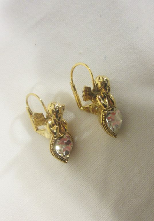This is a charming pair of pierced earrings, each earring depicting a cherub resting its elbows on a clear rhinestone heart. They are in excellent vintage condition and each measures 1/2