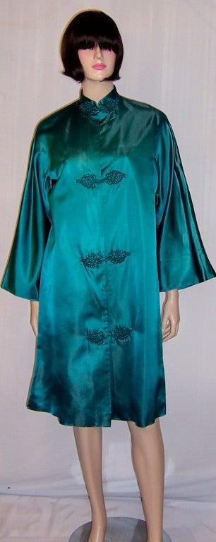 This is a lovely teal silk Chinese robe/coat, straight and loose fitting, with bell-shaped sleeves, a manadrin collar, and the customary frogging fasteners. It is marked a Size Small and is in excellent vintage condition. It would look fabulous when