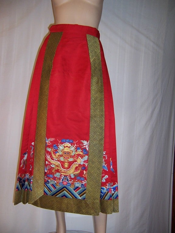 Offered for sale is this vintage, probably 1960's or 1970's, red silk Chinese embroidered and pleated dragon skirt, reminiscent of the dragon robes of years gone by. The dragon has been embroidered with gold metallic couching and is surrounded by