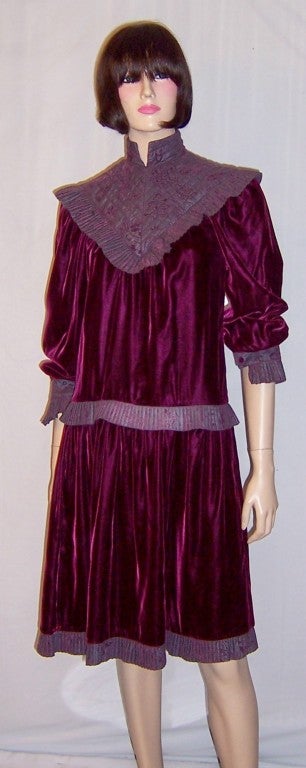 This is a lovely 1980's design by Bis. Gene Ewing of Paris and Beverly Hills, quite reminiscent of a 1960's silhouette. The plum colored brocaded mandarin collar extends to a point in both the front and the back of the dress. The same fabric