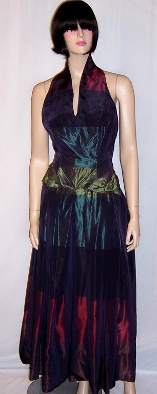 This is an astonishingly beautiful silk taffeta halter-neck gown in an unusual color palette of burgundy, midnight-blue, teal, and moss green horizontal stripes. The label is present and in tact and reads Arduase, 5 Avenue Matignon, Paris. 5 Avenue