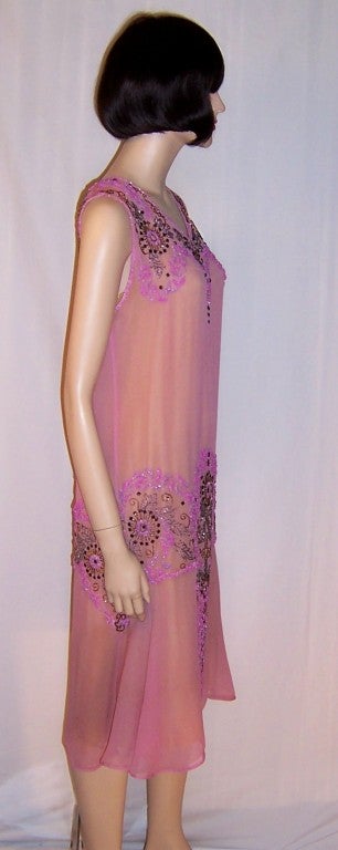 This is a breathtakingly beautiful 1920's raspberry sorbet beaded gown and matching stole of couture quality, workmanship, and design elements in excellent vintage condition. The gown must be slipped over the head to be worn. It measures 17