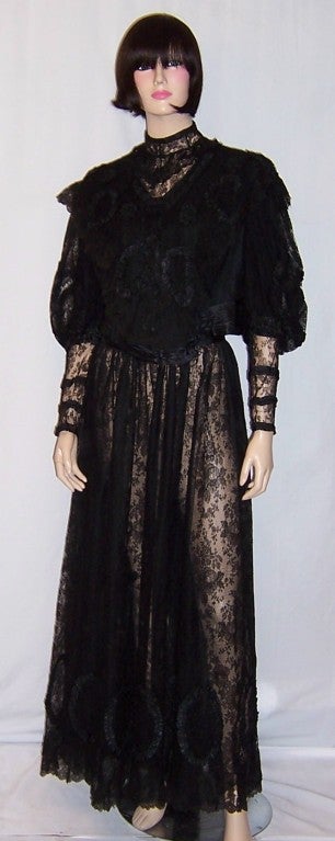 This is a very elaborate Victorian mourning outfit made of fine black lace and beautifully executed silk ribbonwork. The decorated bodice and full skirt are of museum or couture quality in their workmanship, design elements, and their hand