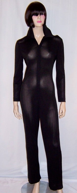 This is a sleek and chic black jumpsuit cut precisely to fit like a glove, designed by James Galanos for Bergdorf Goodman.  Galanos has always been acclaimed for the cut of his designs. He has also always been concerned with the hang of the fabric
