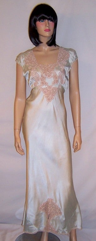 This is an exquisite 1930's vintage, buttery soft silk negligee in pale aqua, with capped sleeves, attached ties to be tied into a bow at the back, and trimmed in gorgeous re-embroidered ecru lace around the bodice and again at the bottom of the