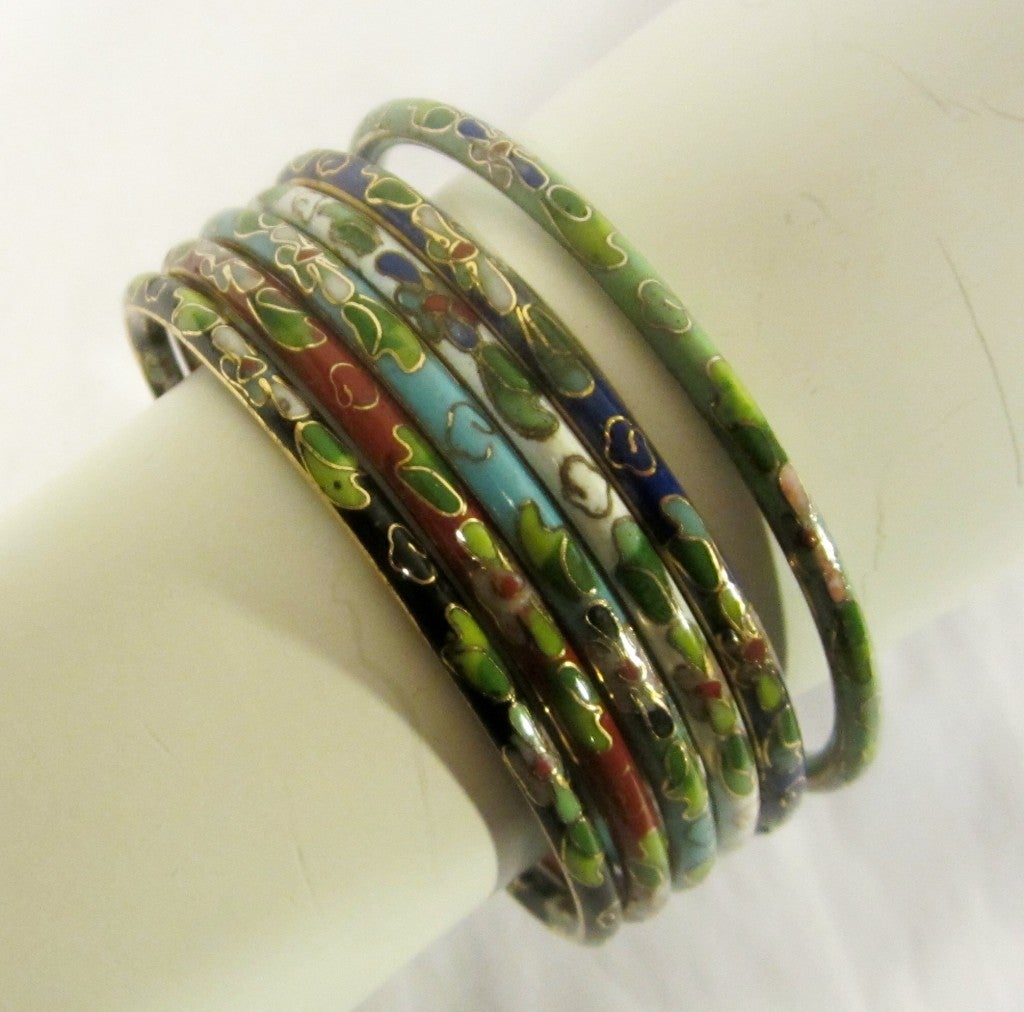 This is a lovely set of six Chinese cloisonne bangle bracelets in white, turquoise, sienna, black, green, and cobalt blue. Each bracelet measures 7