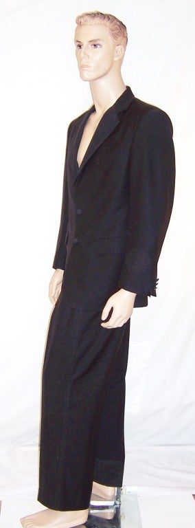 Offered for sale is this handsome and timeless in design, black wool tuxedo designed by Ralph Lauren for his Polo label. The suit is a 40 Regular and the pants measure 34