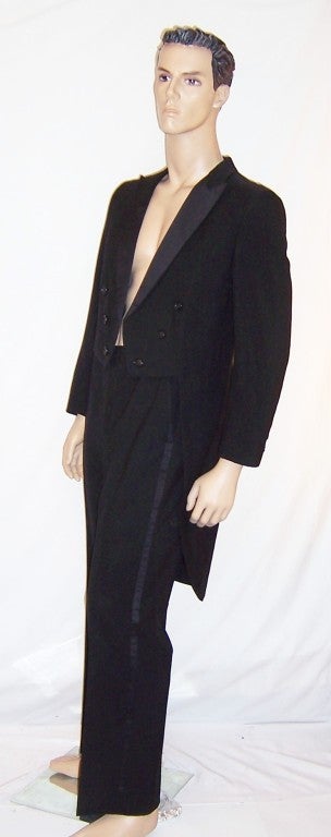 This is an exceptionally stunning black, double breasted tuxedo with tails by Palm Beach Formals, tailored in the USA.  The tuxedo is marked a 36R.  The jacket from shoulder seam to shoulder seam, across the back measures 18