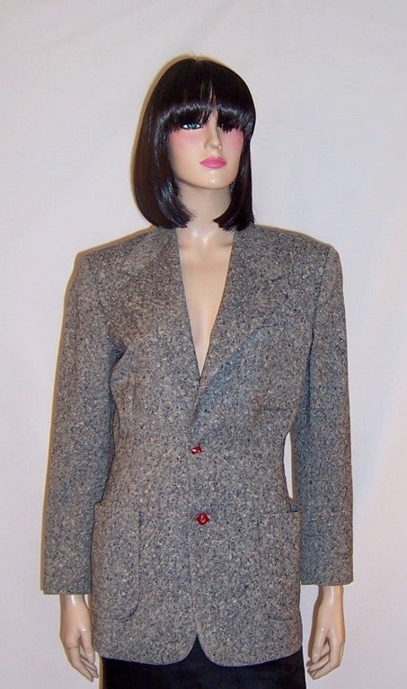 This is a stylish and beautifully cut, 1940's vintage, navy, white, and red tweed blazer with decorative red buttons from the same time period. Its previous owner had replaced the original gray buttons with these decorative red ones which actually