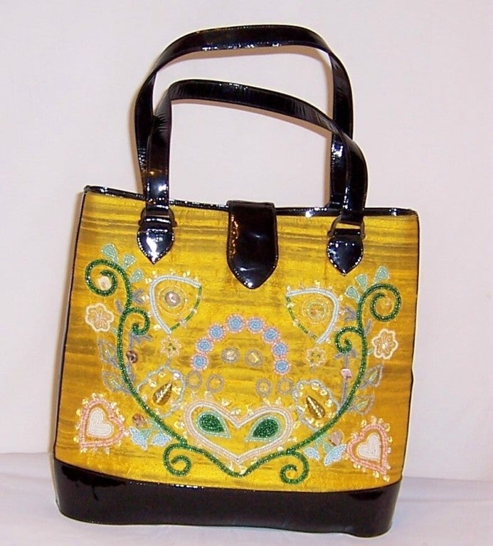This is an unusually lovely Philippe Model-Paris, yellow silk and black patent leather beaded bag. Philippe Model started out as a milliner working for Madame Paulette and in 1981 launched his own label designing gloves, bags, and shoes. This