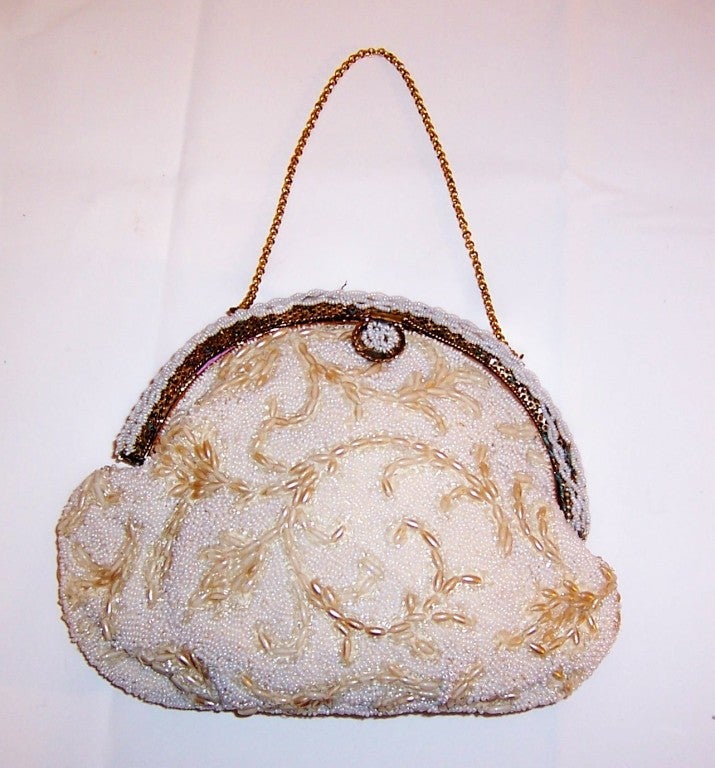This is an exquisitely designed and hand-crafted, Jolles Original, white seed beaded purse from the 1950's vintage. The frame and the clasp or the hardware of a purse is usually what sets a bag apart as being a precious object and this purse is no