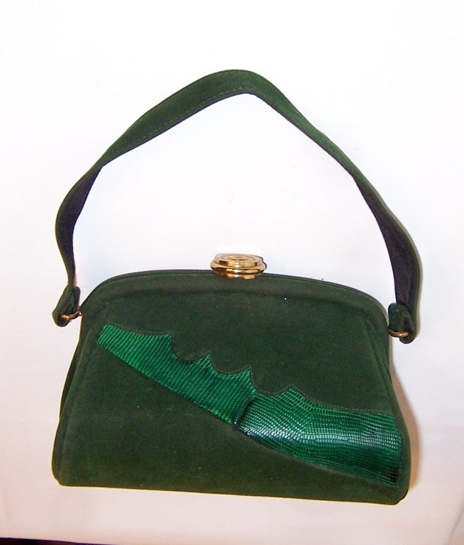 Offered for sale is this unusual, green velveteen and dyed green lizard, pouch-type bag with a chunky rounded gold-toned clasp. The bag measures 7 1/2