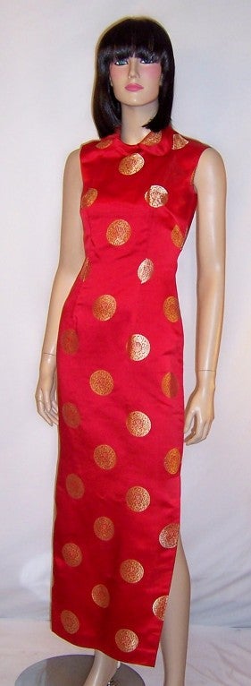 This is a sleek and sensual, 1960's vintage, red silk brocaded sleeveless cheongsam with gold medallions, which in all probability had been custom made.  It is beautifully constructed and has been made to fit like a glove with a side zipper on the