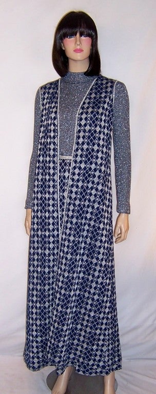This is an handsome and stylish, mid-1960's vintage, navy and silver maxi-dress and long tunic ensemble designed by Louis Feraud by Rembrandt and made in England.  The maxi-dress has long sleeves, a modified turtleneck collar, a back zipper for