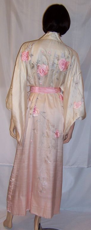 This is an exquisitely crafted, hand-embroidered, circa 1920's, buttery soft silk Japanese kimono embellished with pink sprays of roses. What makes this kimono especially beautiful is the ombre color treatment of the fabric going from white to very